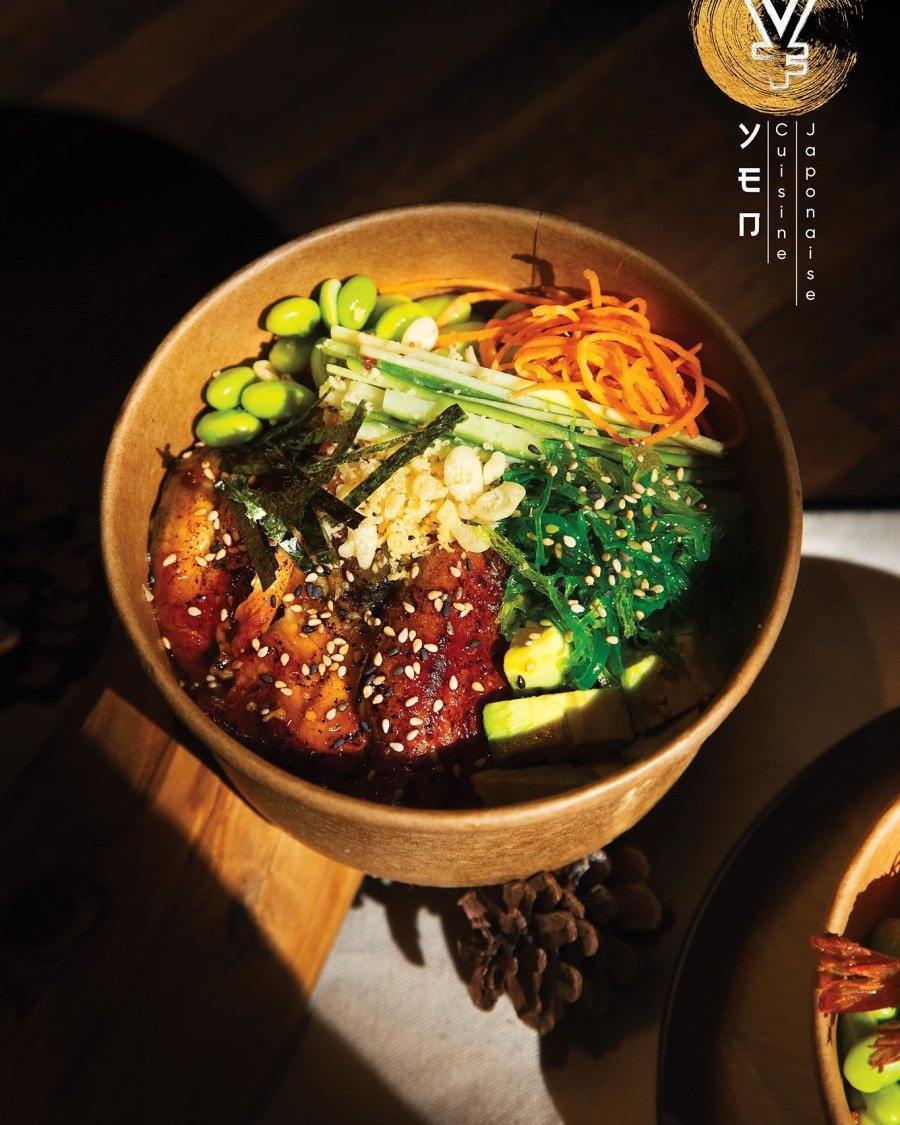 Fresh salmon poke bowl with avocado and crispy vegetables in Montreal restaurant