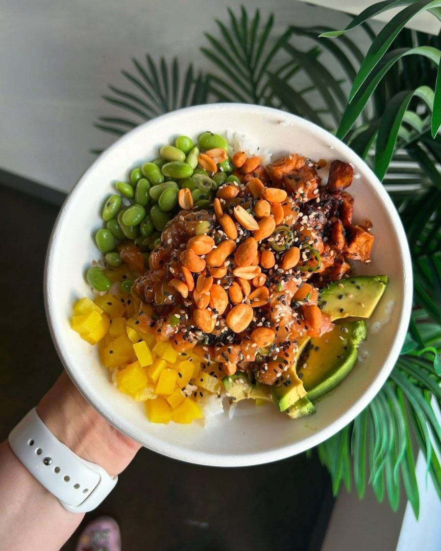 Chef preparing poke bowl in open kitchen counter at Montreal restaurant